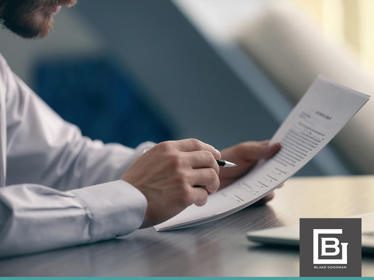 Close-up of a man reviewing bankruptcy documents at a desk