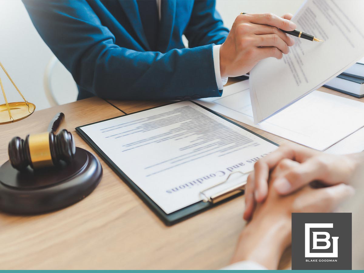 Lawyer explaining debt settlement terms to a client with legal documents and gavel on the desk