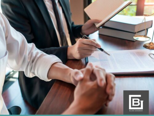 Lawyer reviewing Chapter 13 Bankruptcy documents with a client in an office setting