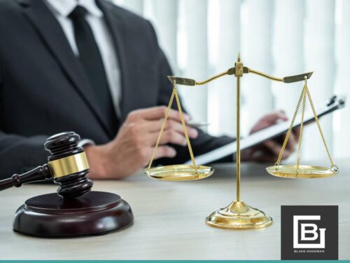 Legal professional reviewing Property Liens impact on bankruptcy with gavel and scales at Blake Goodman, PC