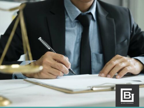 Bankruptcy attorney signing legal documents at a desk